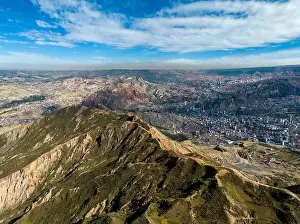 Aerial view from the impressive landmark Muela del Diablo over the mountains down into the valley with the cities La