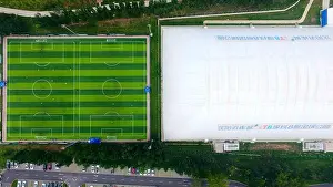 Footballer Prints: Aerial view of indoor and outdoor football pitches at the 'Li Tie Number 8 Football Park' in Shenyang city