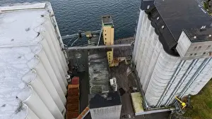 Directly Above Prints: Aerial view of industrial silos and buildings near a body of water