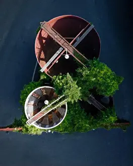 Pearl Prints: Aerial view of industrial structures surrounded by greenery and modern architecture