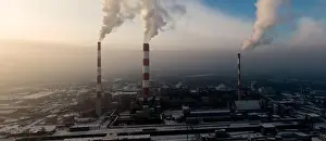 Aerial view of Industrial zone, plants and factories with smoke from chimneys. Air pollution concept. Panorama