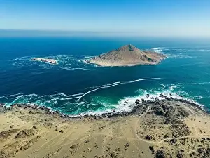 Pan De Azucar Prints: Aerial view of Isla Pan de Azúcar in the National Park Pan de Azúcar at the coast of the Atacama desert in Chile