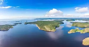 Pine Wood Prints: Aerial top view to island Kilpola overgrown with sparse trees in summer sunny day