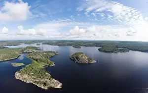 Pine Wood Prints: Aerial top view to island Kilpola overgrown with sparse trees in summer sunny day
