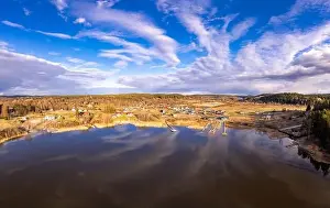 Mountain River Prints: Aerial top view to island overgrown with sparse trees in summer sunny day