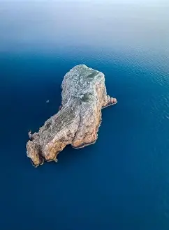 Isola Prints: Aerial view of Isola Foradada island in front of the rocky promontory of Capo Caccia at sunset