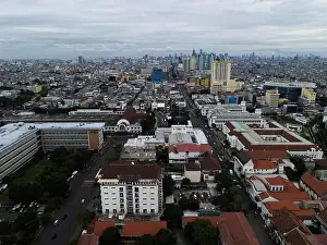 Aerial view of Jakarta Kota Train Station with Jakarta cityscape background. JAKARTA, INDONESIA - DECEMBER, 30, 2020