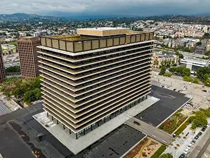High Rise Prints: Aerial view of the John Ferraro Building in Los Angeles with surrounding cityscape and cloudy sky
