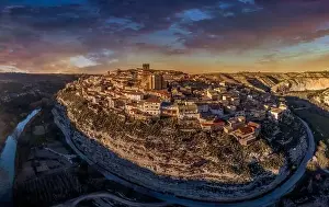 Castilla La Mancha Prints: Aerial view of Jorquera medieval town with city walls and castle circled by the bend of the Jucar river in Spain