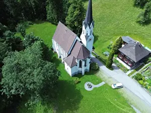 Town Road Prints: An aerial view of Kuratienkirche Meschach surrounded by lush greenery. Gotzis, Austria
