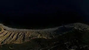 Footage Prints: Aerial view of the lake coast line with dark blue water surface