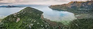 Shkoder Prints: Aerial view of Lake Skadar surrounded by mountains and lush forests in Montenegro