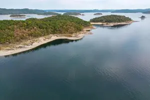 Forestry Industry Prints: Aerial view of landscape of water of Broken Bow lake and islands with forest on the bank