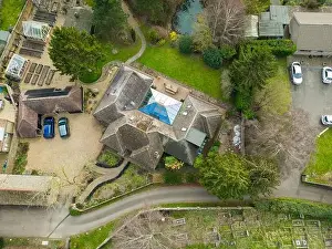 Driveways Prints: Aerial view of a large, detached bungalow with a large garden and pond