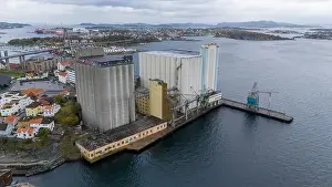 Directly Above Prints: Aerial view of a large industrial silo complex by the waterfront