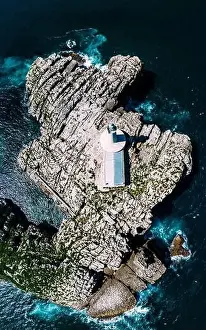 Cantabria Prints: Aerial top down view of lighthouse and Island of Mouro at the entrance of the Bay of Santander in Spain