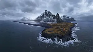 Eystrahorn Prints: To aerial view of lighthouse located on south coast of Iceland near waving blue water against cloudy sky in Eystrahorn