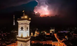 Central City Prints: Aerial view on Lviv city hall at night from drone with lightning on the sky