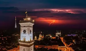 Central City Prints: Aerial view on Lviv city hall at night from drone with lightning on the sky