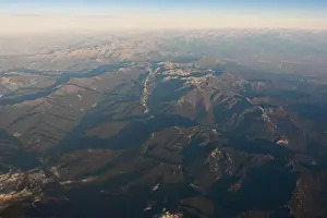 Uneven Prints: Aerial view of magnificent mounts with dry rough surface under cloudy sky at dawn in Dolomites Italy