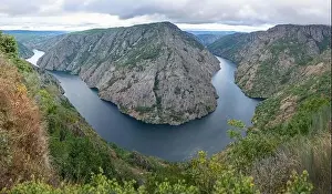 Aerial view of majestic rocky mountains and river at Cies Island in Galicia