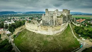 Renovated Prints: Aerial view of medieval ruined Beckov castle in Slovakia above the Vah river with Gothic chapel and stormy sky
