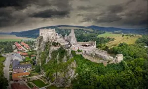 Renovated Prints: Aerial view of medieval ruined Beckov castle in Slovakia above the Vah river with Gothic chapel and stormy sky