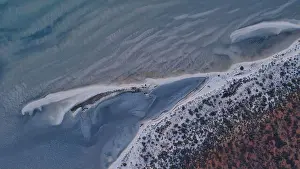 Tidal Prints: Aerial view of the meeting of turquoise sea and red land