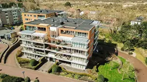 Landscape Architecture Prints: Aerial view of modern apartment building with balconies and garden in suburbs during sunny day