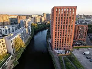 Urban Living Prints: Aerial view of modern apartment buildings with the river Irwell and city skyline in the background