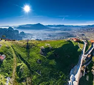 Trikala Prints: Aerial view of monastery of landmark canyon of Meteora and breathtaking picturesque valley at sunset