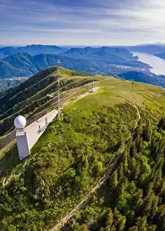 Aerial view from the top of Monte Lema towards Lake Maggiore with its cableway and refuge