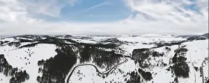 Snowboard Prints: Aerial view of mountain landscape with road and lake in beautiful winter environment