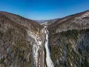 Aerial view on mountain road from drone in winter