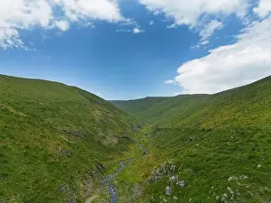 Aerial view mountain. Scenic aerial view from forest to mountain ridge. Above green landscape with sunlight mountains