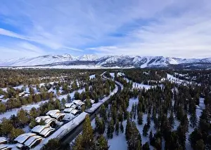 An aerial view of the mountain town of Mammoth Lakes, California during a snowy winter
