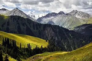 Scenic Road Prints: Aerial view of the mountain valley with lush forest and snowy peak in Kazakhstan