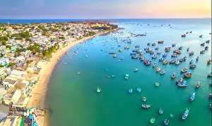 Commercial Dock Prints: Aerial view of Mui Ne fishing village in the morning with hundreds of boats anchored to avoid storms