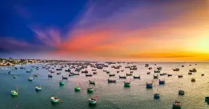 Experiences Prints: Aerial view of Mui Ne fishing village in sunset sky with hundreds of boats anchored to avoid storms