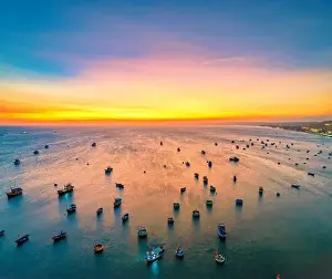 Experiences Prints: Aerial view of Mui Ne fishing village in sunset sky with hundreds of boats anchored to avoid storms