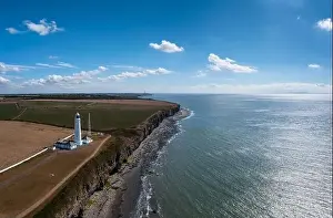 Rocky Beach Prints: Aerial view of the Nash Point Lighthouse and Monknash Coast in South Wales
