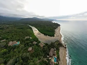 Treetop Prints: Aerial view of nature, hills, and beach of Los Naranjos in Santa Marta by Tayrona National Park in Colombia