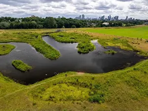 Green Space Prints: Aerial view of a newly created Kersal wetland park with Manchester city skyline in the background