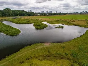 Green Space Prints: Aerial view of a newly created Kersal wetland park with Manchester city skyline in the background