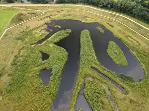 Green Space Prints: Aerial view of a newly created Kersal wetland park with Manchester city skyline in the background