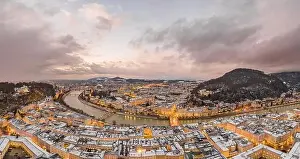 Salzach Prints: Aerial view of northern Salzburg city along river during sunset hour in snowy winter