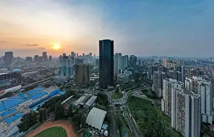 Aerial view of office buildings in Jakarta central business district and noise cloud when sunset