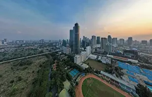 Jakarta Prints: Aerial view of office buildings in Jakarta central business district and noise cloud when sunset