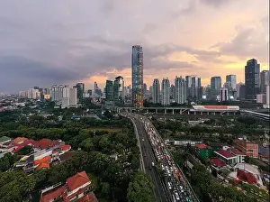 Jakarta Prints: Aerial view of office buildings in Jakarta central business district and noise cloud when sunset