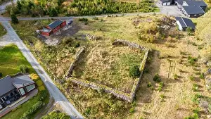 Rural Area Prints: An aerial view of an empty plot of land surrounded by greenery and structures